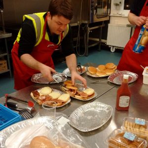 RRT cooking up sausage and bacon rolls for the evacuated people
